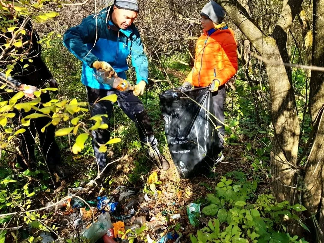 father and son collecting rubbish